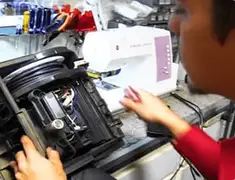 Vacuum repair technician servicing internal components on a workbench in Detroit, MI