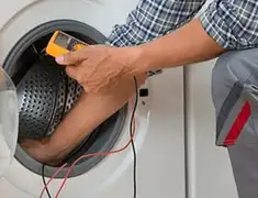 Washing machine repair technician testing a front-load washer with diagnostic tools in Detroit, MI